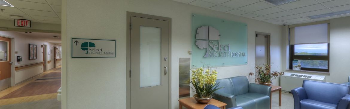 The entrance to Select Specialty Hospital Grosse Pointe featuring a sign and the hospital hallway.