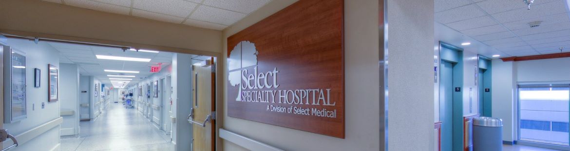 An image showing the entrance of Select Specialty Hospital - Tulsa. The photo features a sign with the hospital name.