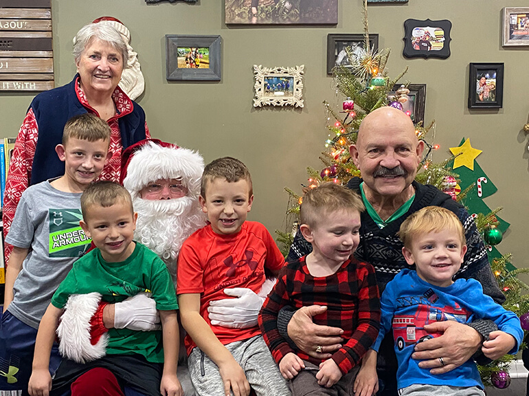 Bill and Rita Rawlings at home with their five grandchildren after recovering from Covid-19.