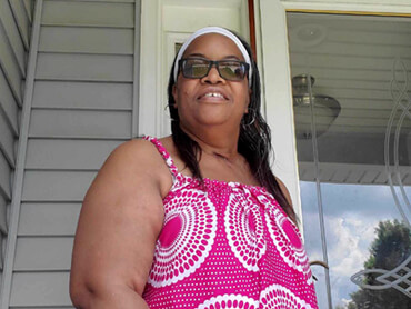 Charlene Jones home from the hospital and standing on her porch after successful respiratory recovery from Covid 19.