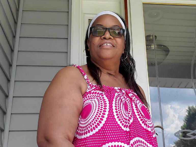 Charlene Jones home from the hospital and standing on her porch after successful respiratory recovery from Covid 19.