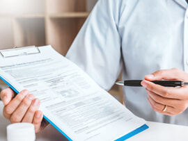 close-up of person holding a clipboard with an insurance document