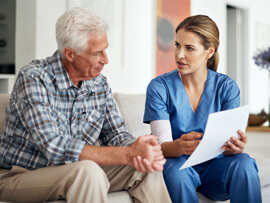 older male patient and nurse discussing Medicare documentation