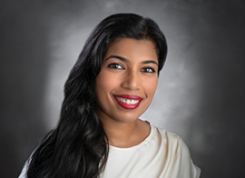 Dr. Vanitha smiling at the camera.