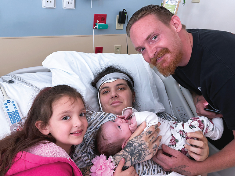 Alexandria and her family looking at the camera.