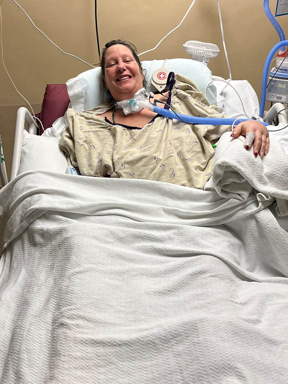 Christine in a hospital bed.