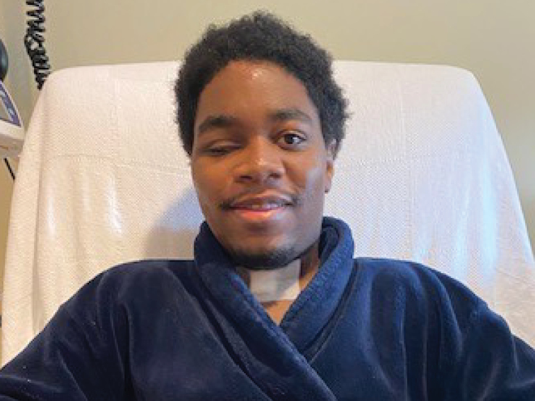 Jay looking at the camera in a robe.