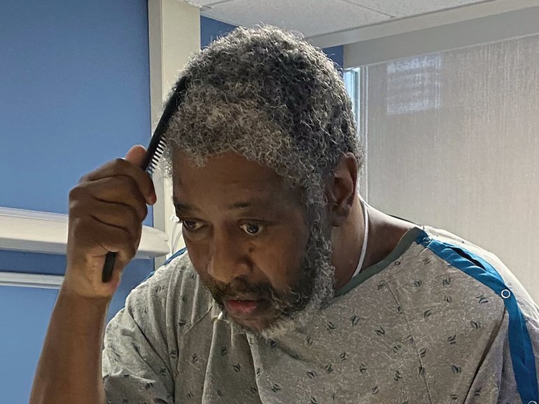 Ozell combing his hair.