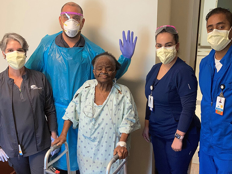 photo of Delores Hall surrounded by her therapists