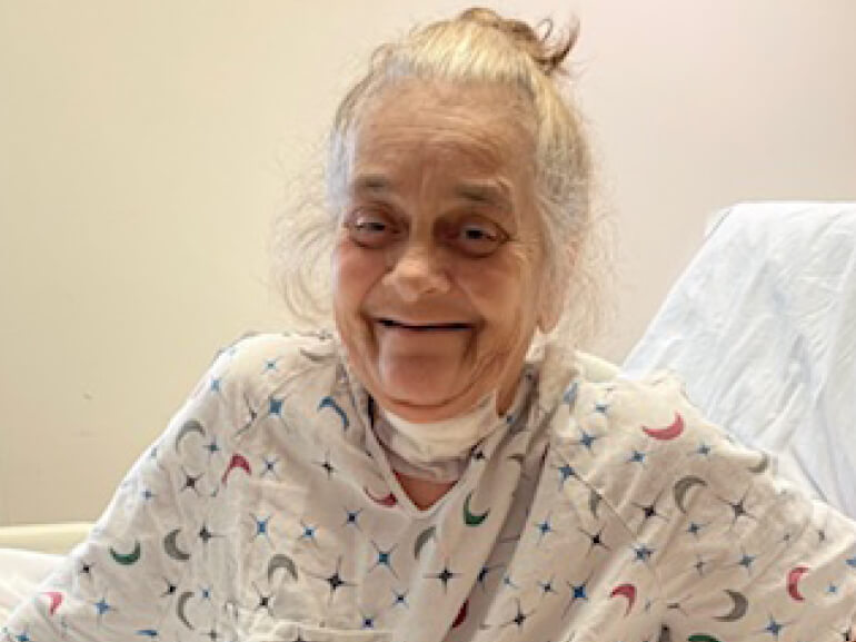 Dawn Yale smiles in her room during recovery.