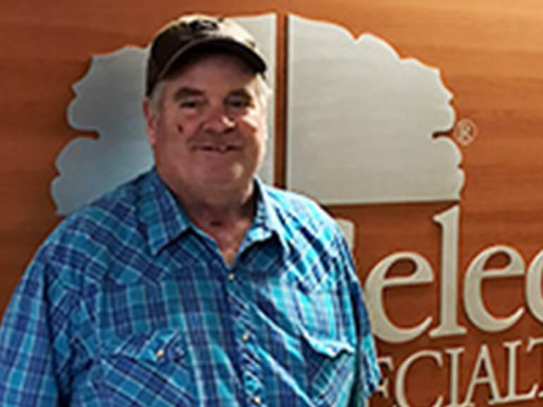 Richard standing in front of the Select Medical logo