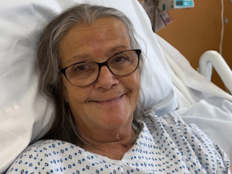 Sandra Faber smiles from her hospital bed.