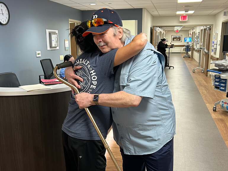 Steve embracing someone.
