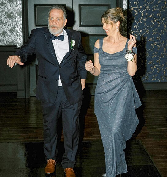 Photo of Warren Leary and his wife Lisa entering their son's wedding. 